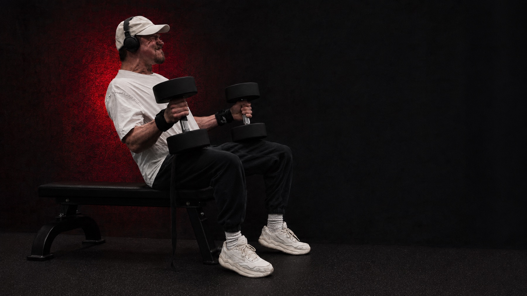 Ian Zubrickas performing seated dumbbell curls